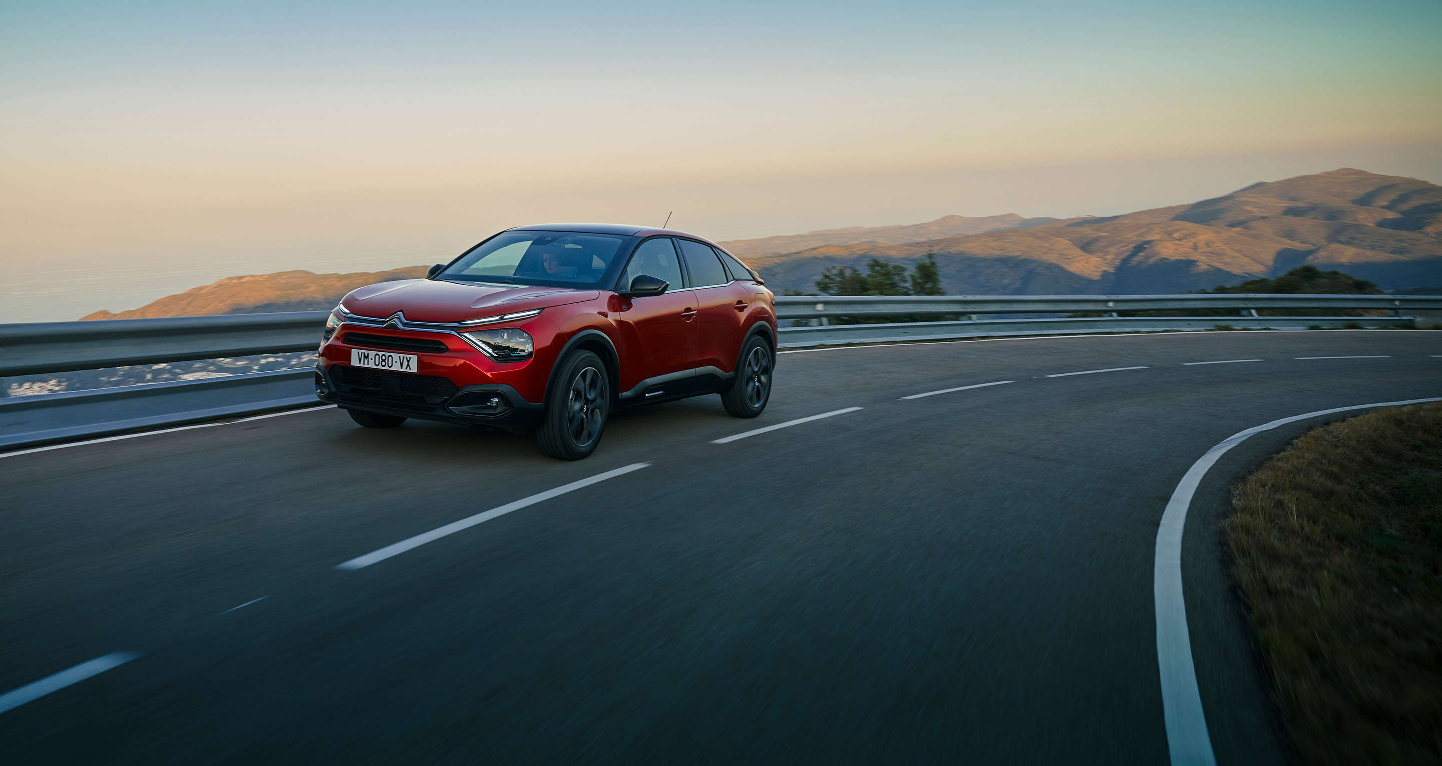 Citroen C4 їде по трасі, вигляд спереду з лівого боку